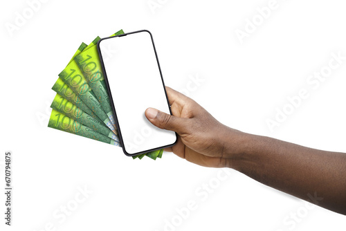 Black hand holding mobile phone with blank screen and Samoan Tala notes photo