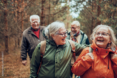 A group of cheerful senior friends enjoying their hiking adventure together