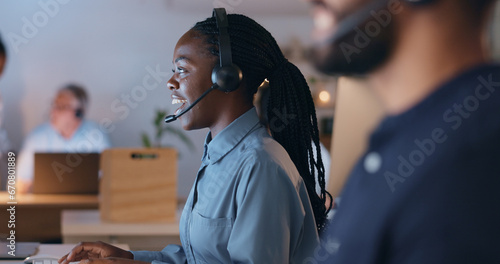 Happy woman, call center and night communication, customer service or e commerce support on computer. Professional consultant or african agent of web solution, questions or business chat in workspace photo