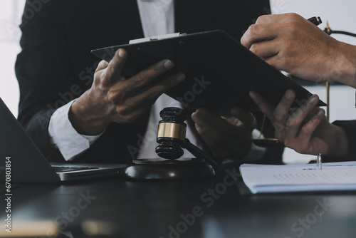 Consultation and conference of Male lawyers and professional businesswoman working and discussion having at law firm in office. Concepts of law, Judge gavel with scales of justice.