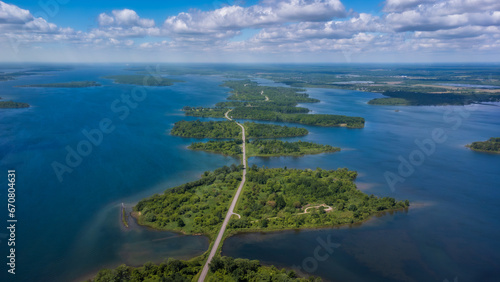 Aerial photo of Long Sault Parkway scenic route crossing Thousand Islands archipelago in the Saint Lawrence River near Cornwall, South Stormont, Ontario, Canada. Photo taken by drone in June 2022.