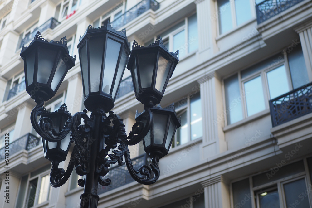 Elegant street lamp against a building Elegant street lamp against a building
