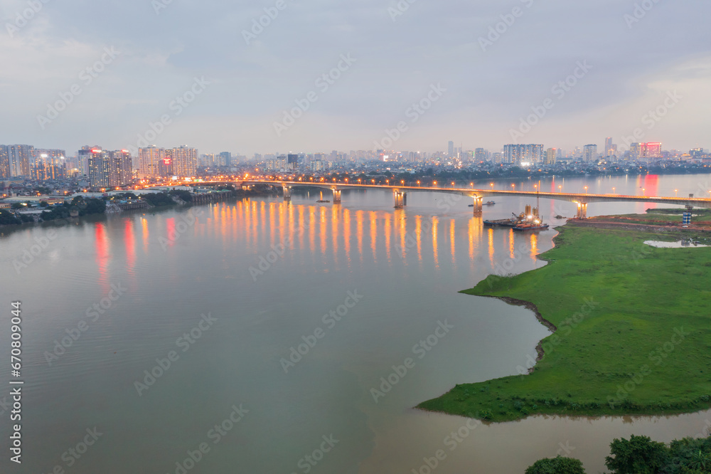 Vinh Tuy bridge crossing Red river in Hanoi during twilight