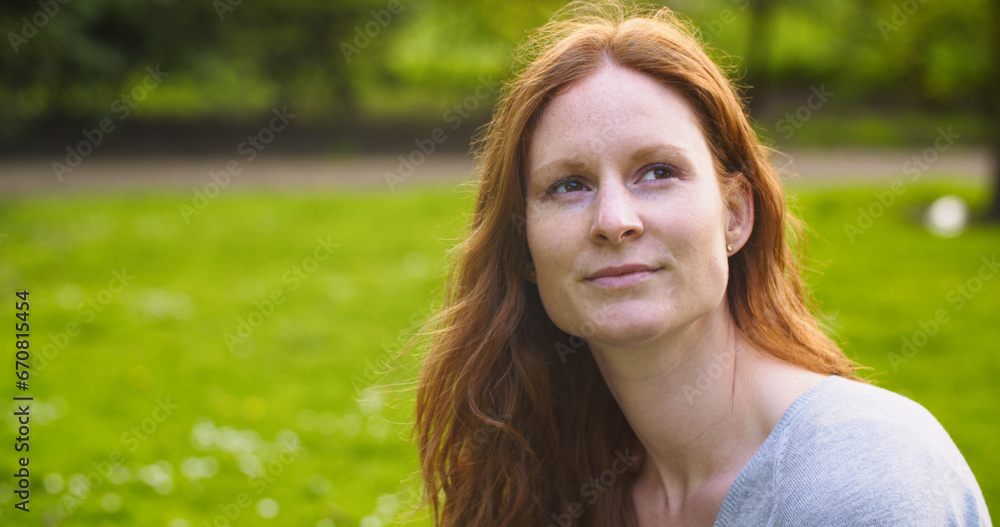 Young Redhead Woman in a Park