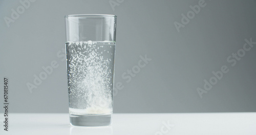 Vitamin effervescent tablet dissolves in a glass of water