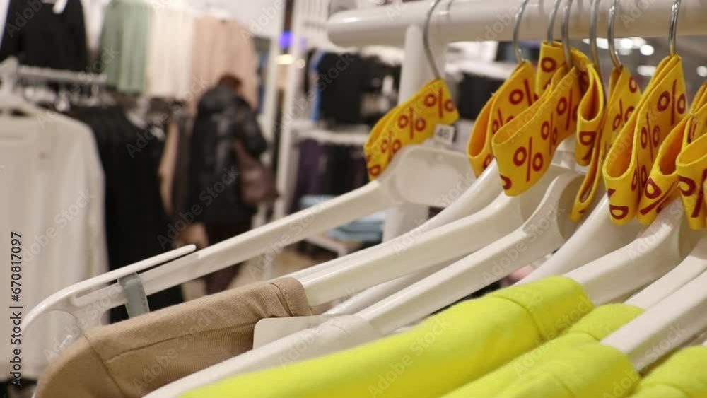 Clothing in a store with a sign of discounts, sales. Discounts and sales Clothing in a store with a sign of discounts, sales. Discounts and sales