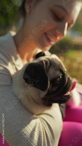 Surrounded by autumn leaves, a charming young lady shares a moment with her dog in the park.