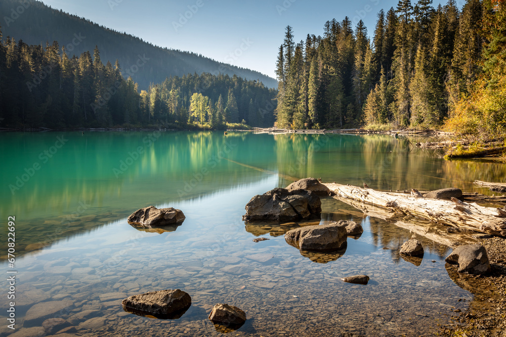 Naklejka premium A very peaceful moment with beautiful warm sunlight at a calm Cheakamus Lake in Whistler, BC, Canada.