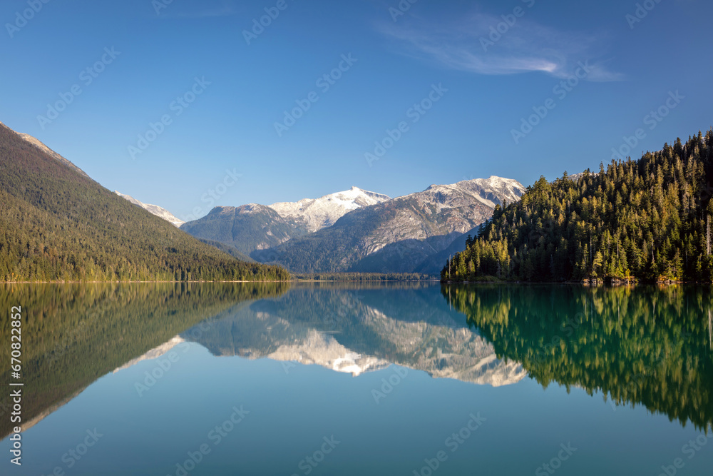 A perfect reflection of the mountains and blue sky at Cheakamus Lake in Whistler, BC