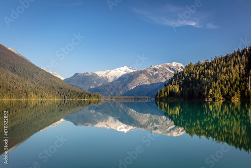 A perfect reflection of the mountains and blue sky at Cheakamus Lake in Whistler  BC