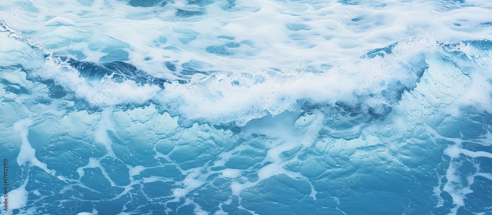 Crashing waves generating foamy surface on the beach Detailed close up of deep blue ocean
