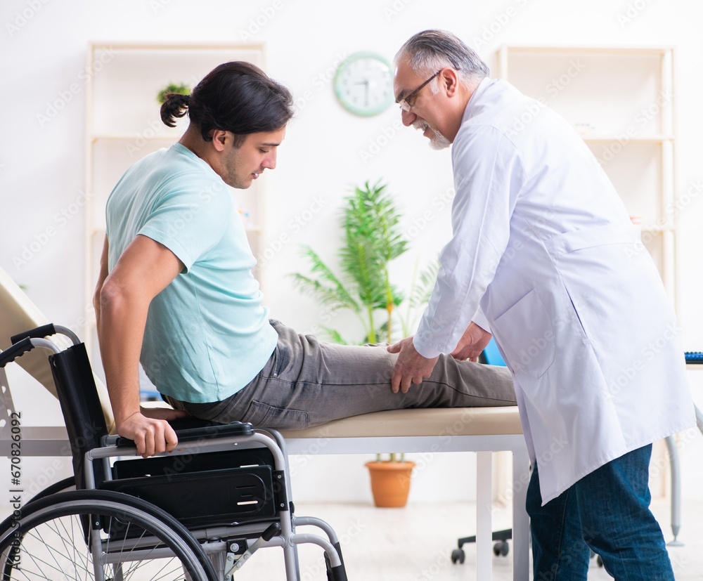 Obraz premium Male patient in wheel-chair visiting old doctor