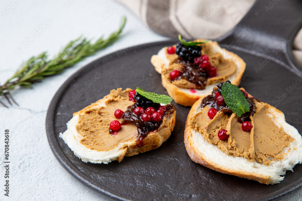 canapes with pate, mint leaves and berries, top view canapes with pate, mint leaves and berries, top view