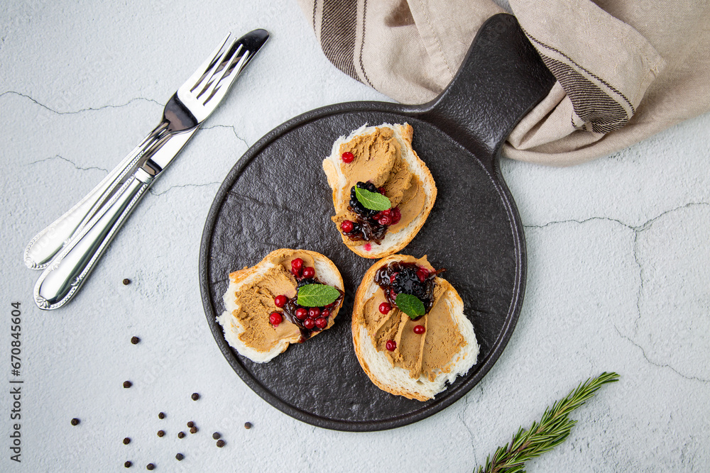 canapes with pate, mint leaves and berries, top view
