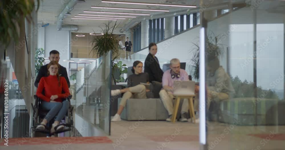 A company director assists his business colleague in a wheelchair, helping her navigate to their startup office, where they work alongside their diverse team of colleagues, emphasizing inclusivity and A company director assists his business colleague in a wheelchair, helping her navigate to their startup office, where they work alongside their diverse team of colleagues, emphasizing inclusivity and