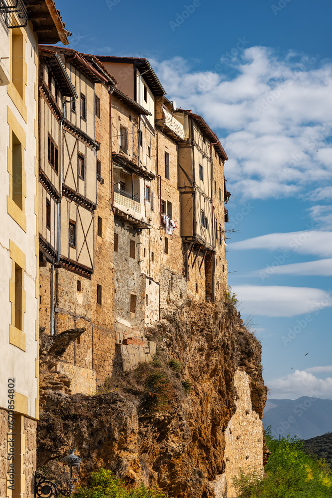Houses perched on the cliff atop the hill of the medieval village of Frias, Spain.
