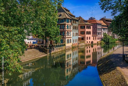 Ornate traditional half timbered houses with blooming flowers along the canals in the picturesque Petite France district of Strasbourg, Alsace, France 