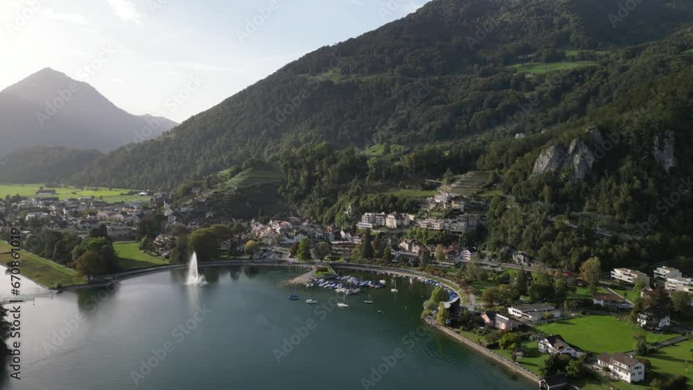 Aerial view of Weesen town based near shore of Walensee lake, Switzerland. Drone flies backwards Aerial view of Weesen town based near shore of Walensee lake, Switzerland. Drone flies backwards