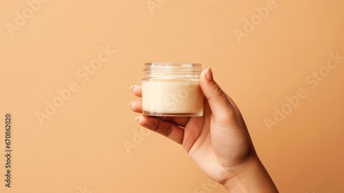 Close up of hand holding a jar of cosmetics product. Skincare hygiene moisturiser photo