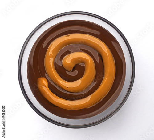 Caramel and chocolate cream swirl isolated on white background, top view