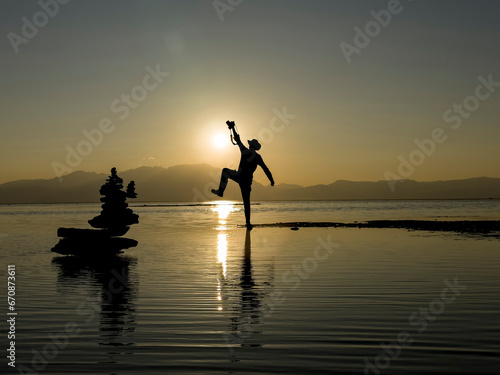 The energetic, enthusiastic and dynamic photographer's lifestyle and his silhouette on the lake