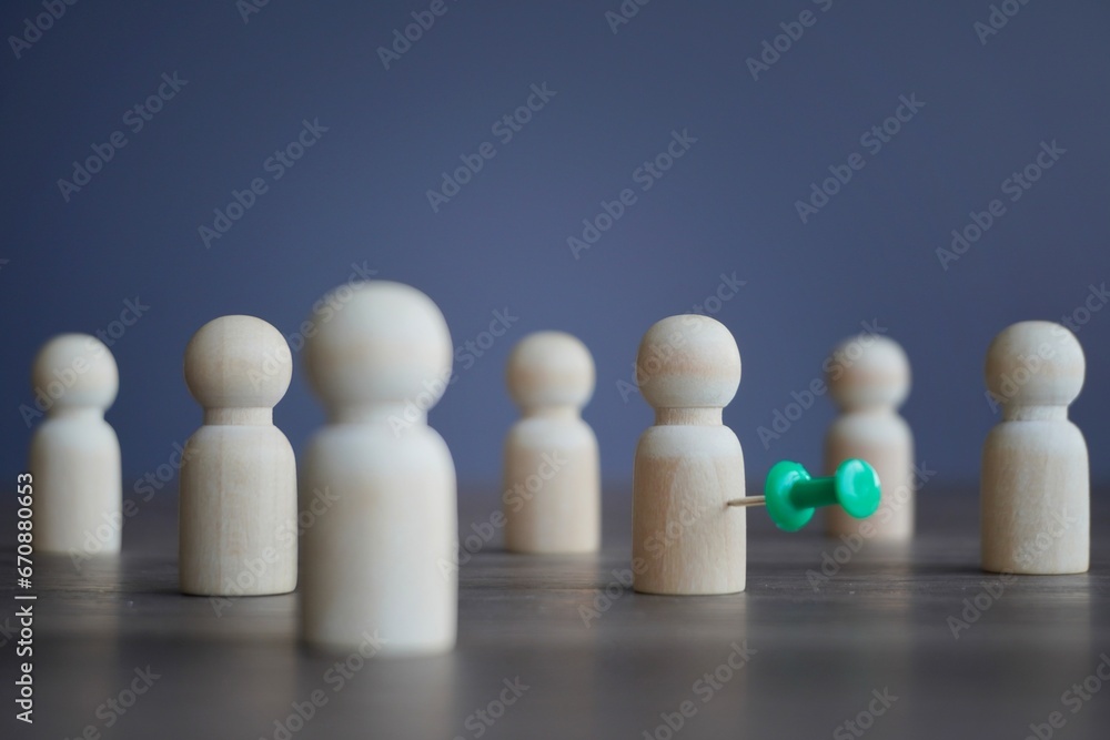 Wooden dolls and pushpin. Target customer, target market and potential client concept. Wooden dolls and pushpin. Target customer, target market and potential client concept.