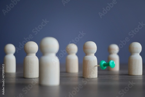 Wooden dolls and pushpin. Target customer, target market and potential client concept.