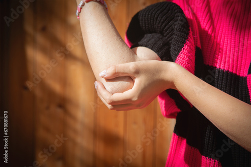 Caucasian woman suffering from elbow pain. photo