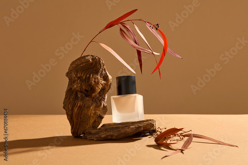 Unbranded glass bottle with foundation base beauty makeup product displayed on a stone. Advertising design template