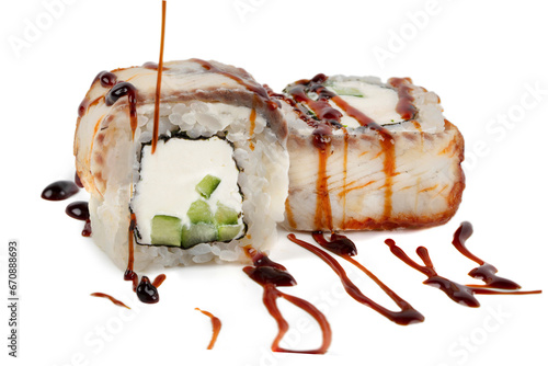 Sushi closeup isolated on white background. Sushi roll with graham rice, Philadelphia cheese and celery topped with soy sauce. Japanese restaurant menu.