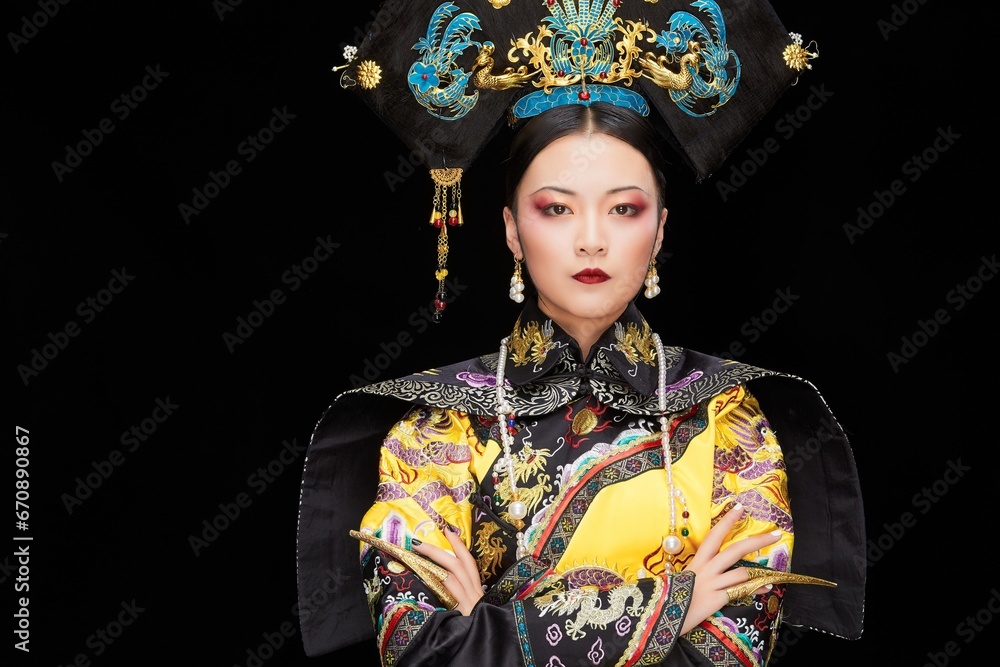 A Asian woman dressed in Qing Dynasty Empress attire A Asian woman dressed in Qing Dynasty Empress attire