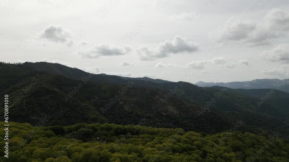 Fluffy clouds and majestic mountain terrain in Spain, aerial view Fluffy clouds and majestic mountain terrain in Spain, aerial view