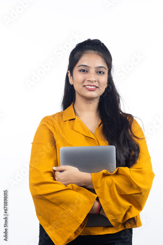 Young Indian, asian business woman, confident female entrepreneur holding laptop wearing professional outfit dress isolated on white background