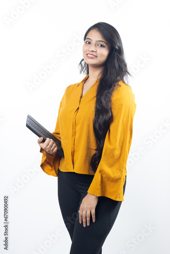 Young Indian, asian business woman, collage girl, student, confident female entrepreneur wearing professional outfit dress holding tablet for advertisement isolated on white background