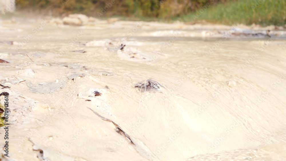 Vertical video stream of hot clean water flows over white deposits of