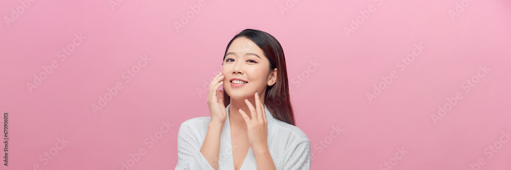 Banner of beautiful face portrait of young woman is applying face cream on a cheek. Banner of beautiful face portrait of young woman is applying face cream on a cheek.