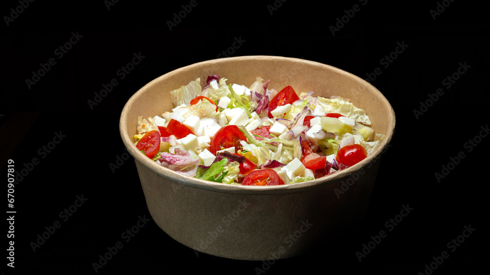 vegetable salad with cheese in a bowl on black background. vegetable salad with cheese in a bowl on black background.