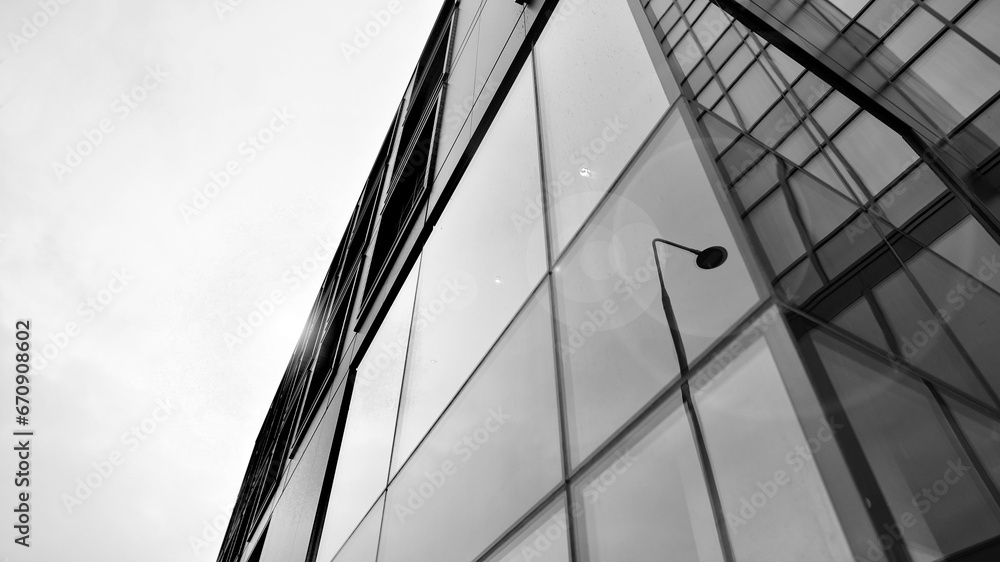 Obraz premium Abstract reflection of modern city glass facades. Modern office building detail, glass surface. Black and white.