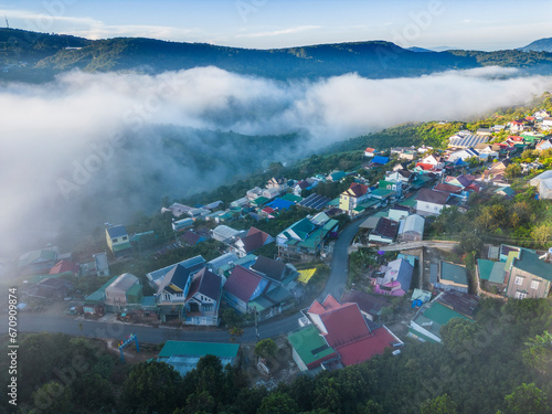 View Dalat city on the foot of Langbian mountain in misty day - Ariel view  photo