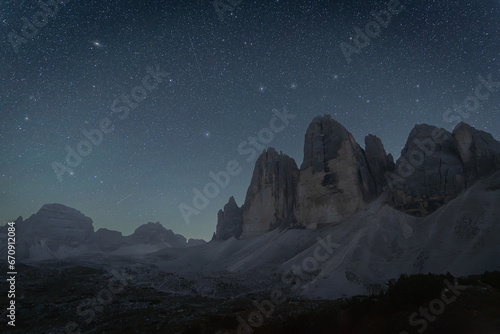 Night sky above massive rock formation, Tre Cime mountains, Dolomites, Italy