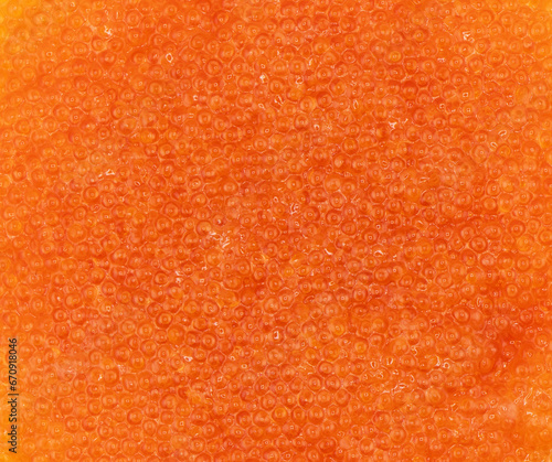 Background texture of salmon fish red caviar. Trout caviar texture pattern.