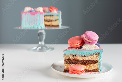 piece of cake with pink and blue decor on white table