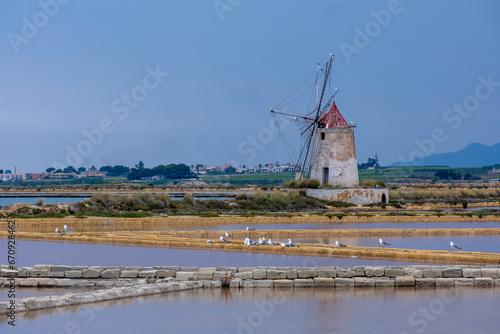 Salt flats with the old windmill, saline dello Stagnone. Marsala, Trapani, Sicily, Italy, Europe.