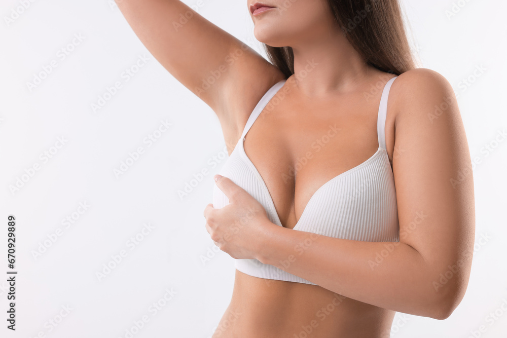 Woman with beautiful breast on white background, closeup. Space for text