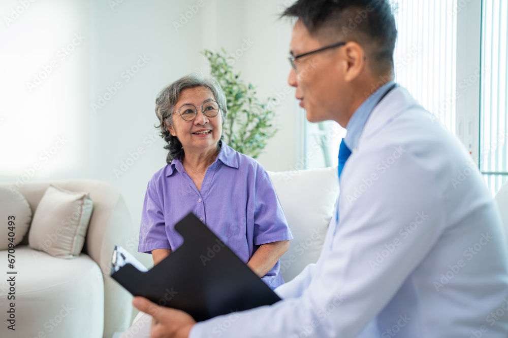 Mature male doctor taking care and talking mature female patient sitting on sofa in hospital. Healthcare concept. Mature male doctor taking care and talking mature female patient sitting on sofa in hospital. Healthcare concept.