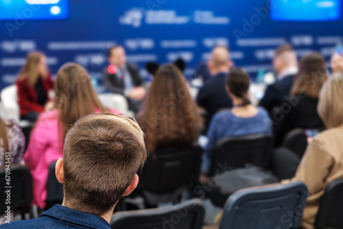 Back view of male professional attending conference meeting at export forum © Anton Gvozdikov
