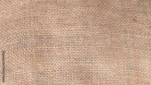 Texture of burlap. Top view of natural brown hessian cloth or gunny sack. Hessian cloth is an inexpensive fabric or garment made of hessian or burlap formed of jute, coarsely woven fabric. 