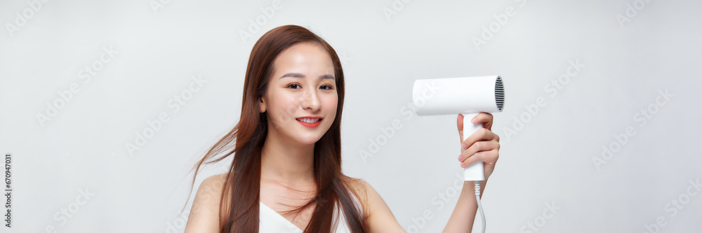 Crop of happy female using blow hair dryer. Crop of happy female using blow hair dryer.