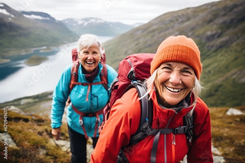 Senior women hiking in the mountains happy portrait. Travel agency tour for retired people marketing campaign.