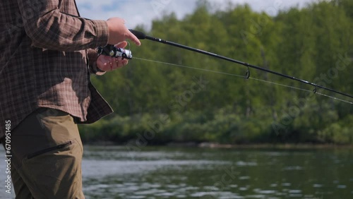 Wallpaper Mural Man fishing at river, close up view of hands, techinque and casting rod. Fixed view Torontodigital.ca